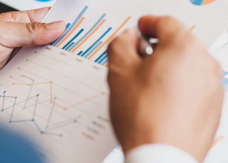 Hands with investment portfolio graph